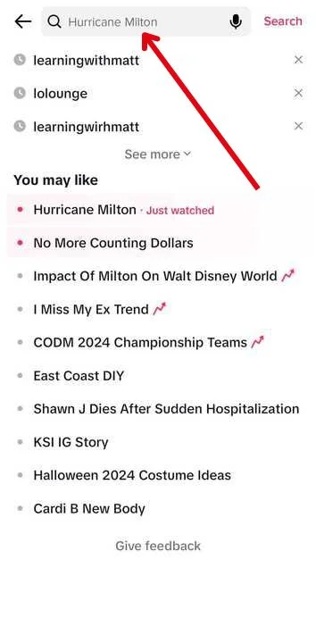 TikTok search bar with 'Halloween videos' typed in, demonstrating how to search for content related to a specific keyword